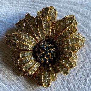 Floral brooch with rhinestones and blue gems.